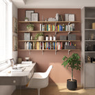 Modern home office with floating bookshelves, desk, and chair.
