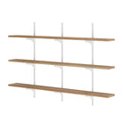 Set of three real wood rustic shelving unit in burnt color with white metal brackets on a white background