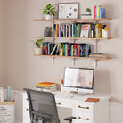 Home office with a desk, computer, and office storage shelves filled with books and plants.