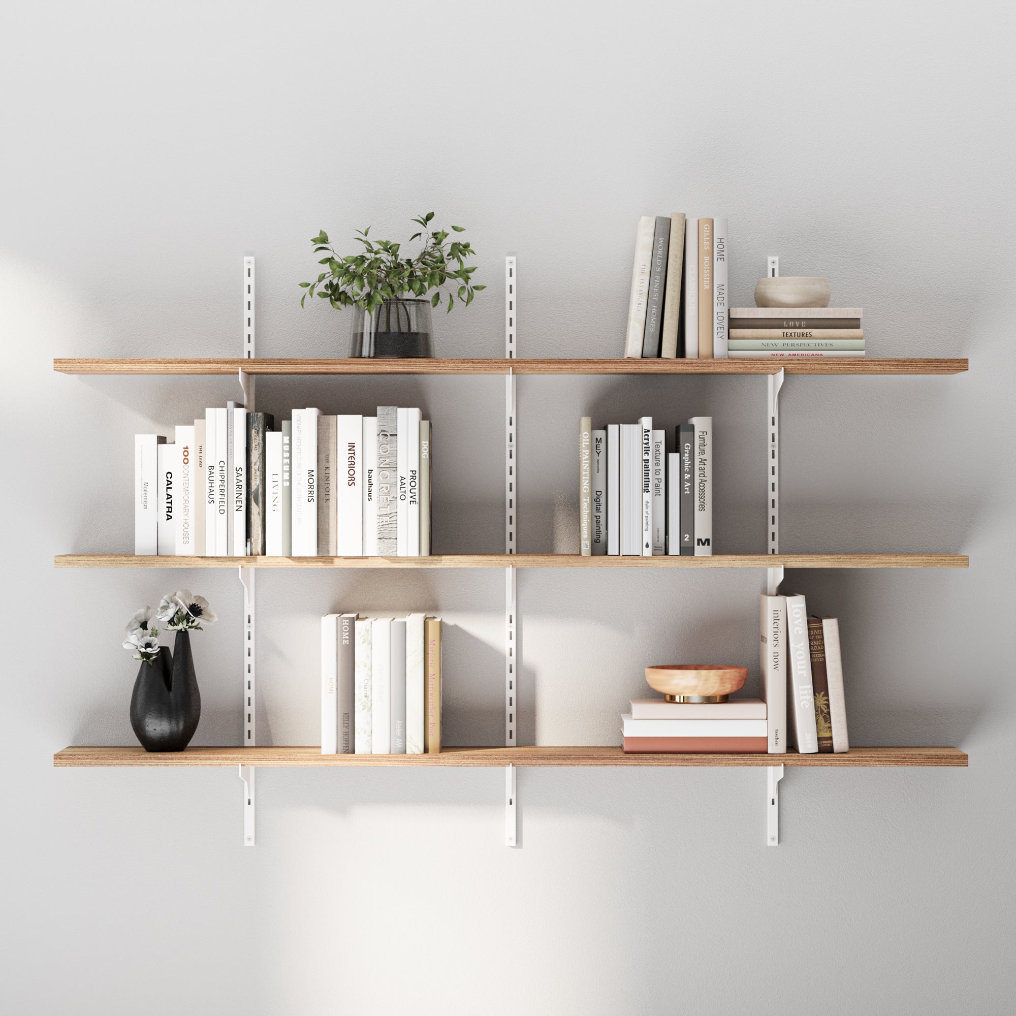 Wooden 3 tiered shelves with books and decorative items against a gray wall