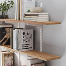 54 inch long farmhouse shelves with books and decorative items against a gray wall