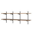 Wall-mounted shelving unit with wooden shelves and metal brackets on a white background