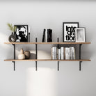 2 tier rustic shelving unit with books and decorative items against a white wall