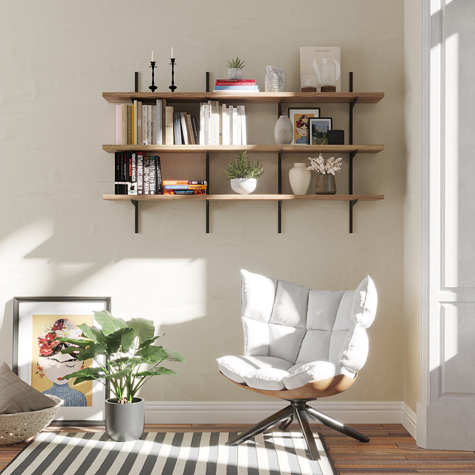 Modern living room with a white chair, striped rug, and 3 tiered wall-mounted shelves in a burnt finish.