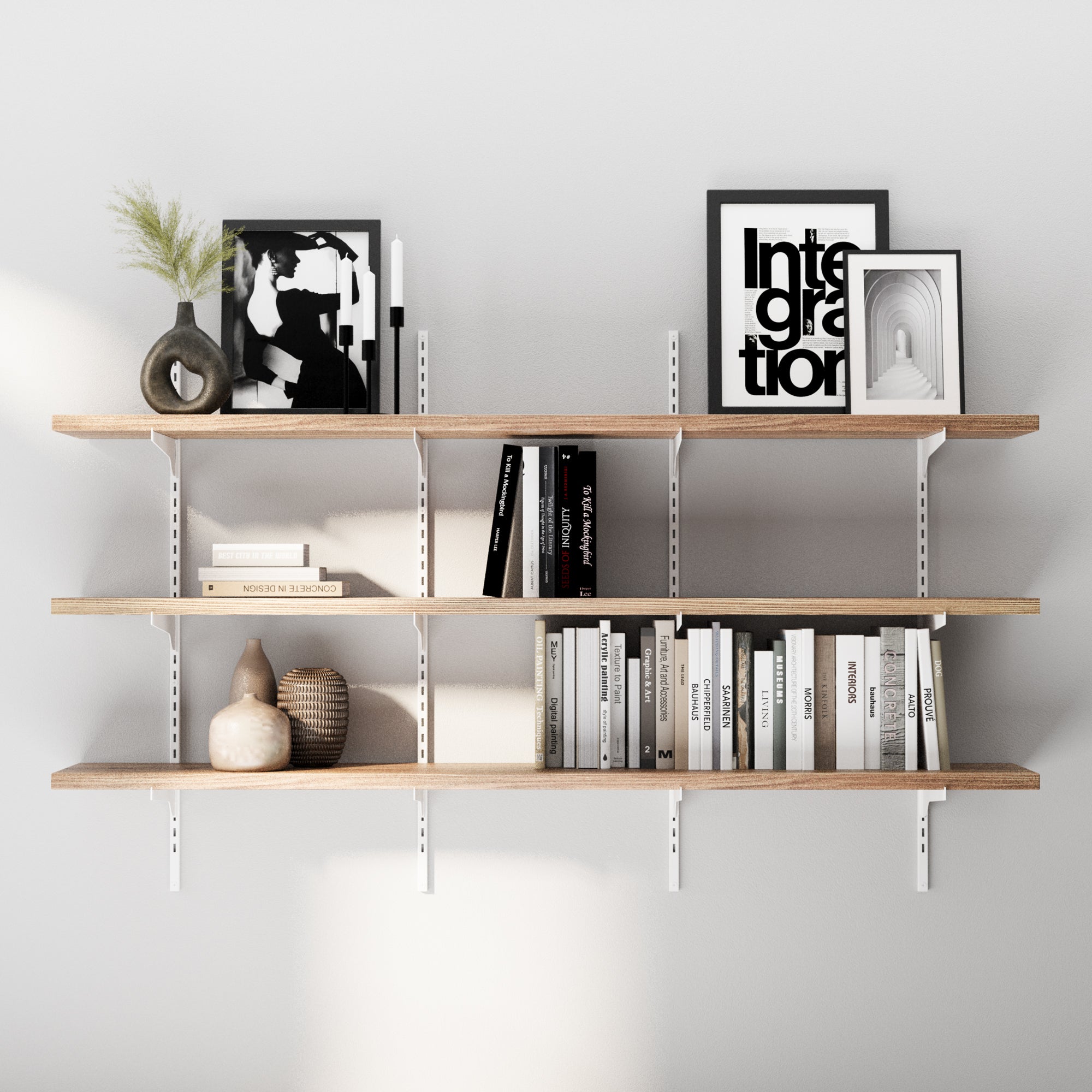 3 tiered decorative shelf with books, frames, and decorative items against a gray wall.