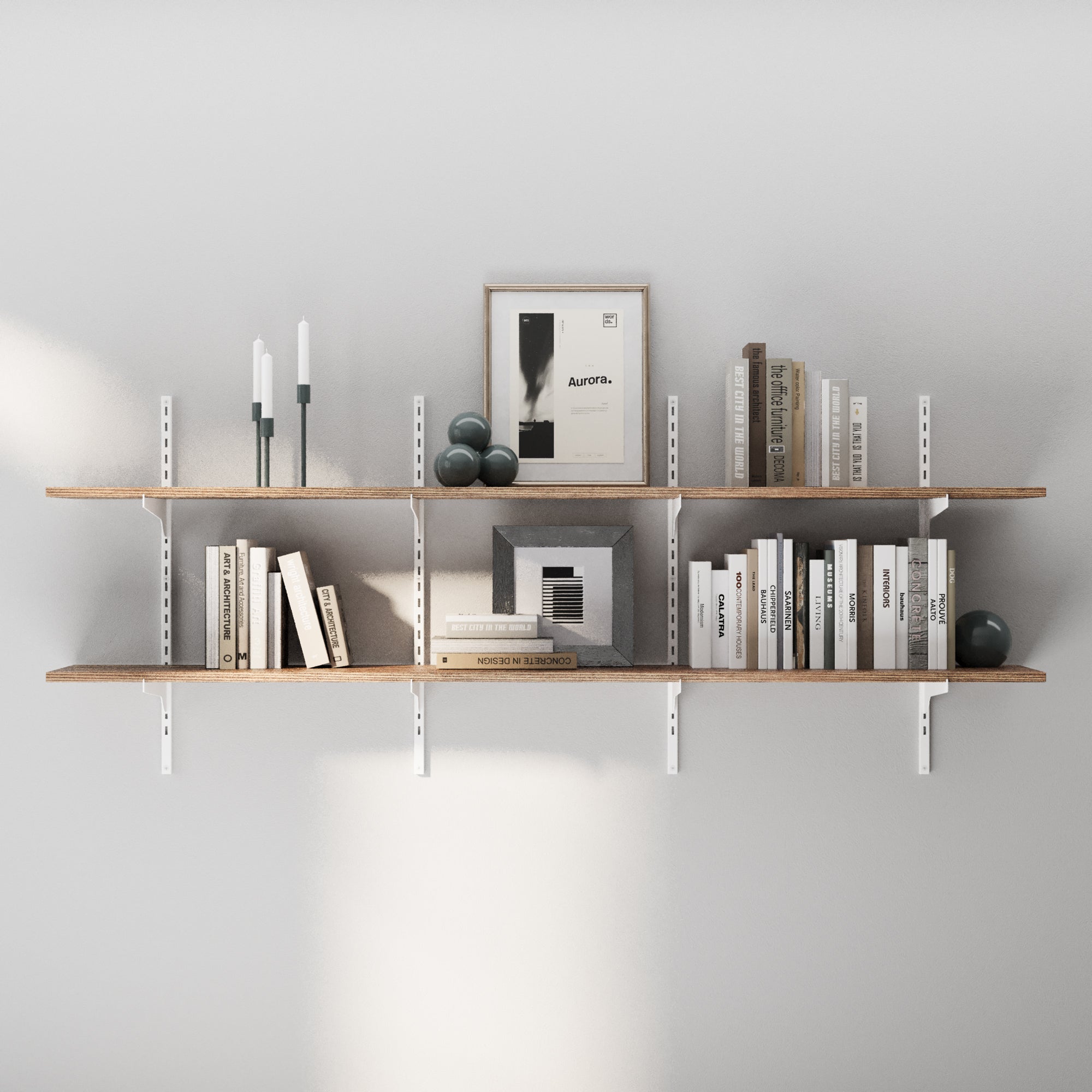 Two long real wood farmhouse shelves with white brackets, arranged with candles, framed art, books, and decorative spheres for a contemporary aesthetic.
