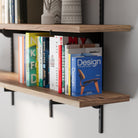 Real wood board and black metal brackets with black rails, showcasing layered wood grain texture, slim profile, and neatly aligned books.
