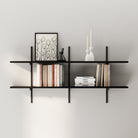 Minimal wall display featuring two black shelves with black brackets, arranged with books, decor pieces, framed artwork, and candles.