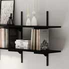 Black wood boards and metal bracket, highlighting smooth matte finish, slim profile, and neatly stacked books.