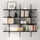 Minimal interior display with four black floating shelves mounted on a light wall, arranged with framed art, candles, books, and neutral decor.