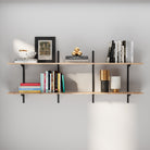 2 tier adjustable shelf with books and decorative items against a gray wall