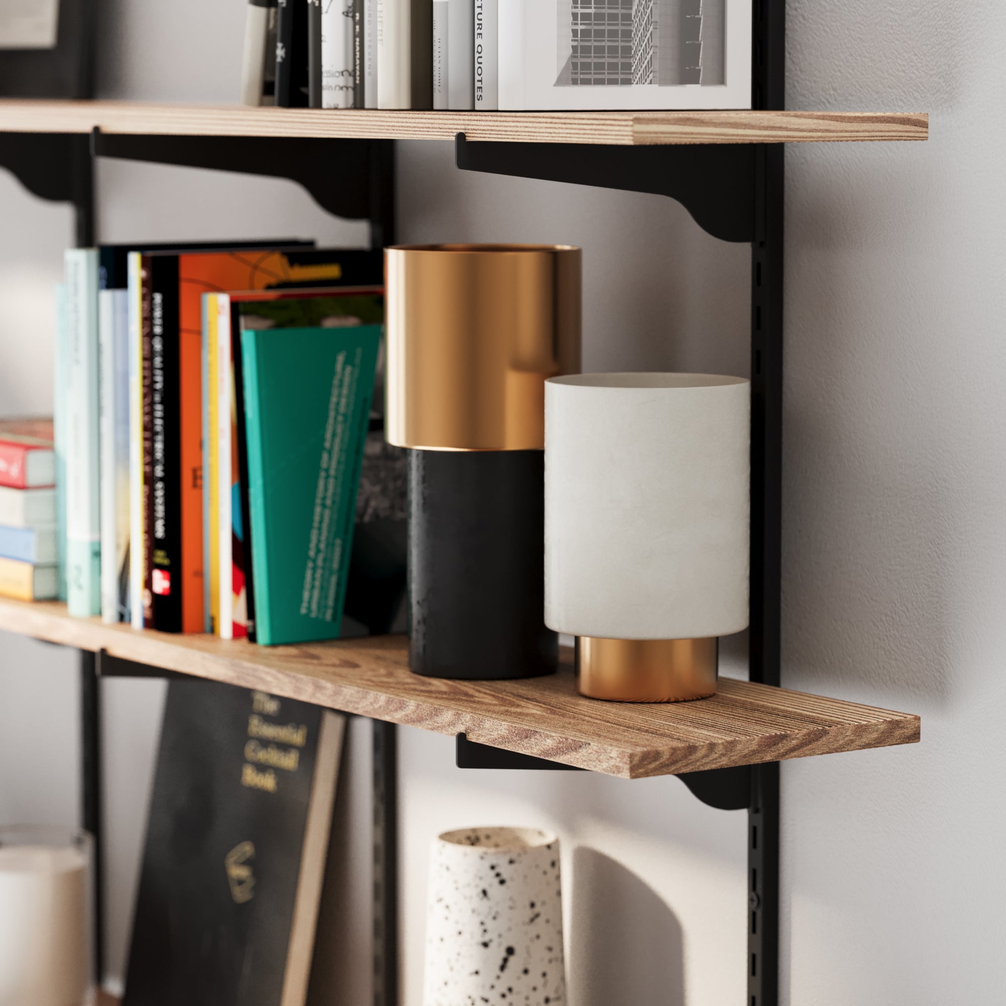 Wooden shelves with books and decorative items against a gray wall