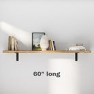 A single floating bookshelf with a sleek black bracket supports books and minimalistic decor, blending simplicity and elegance for a clean wall design.