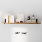 A stylish 48 inch rustic long shelf neatly displaying books, candles, and decorative items. Ideal for compact spaces to showcase essentials with a clean and minimalist design.