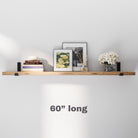 A sleek 60 inch hanging shelf adorned with framed art, books, and flowers. The ideal option for larger spaces to combine storage and décor effortlessly.