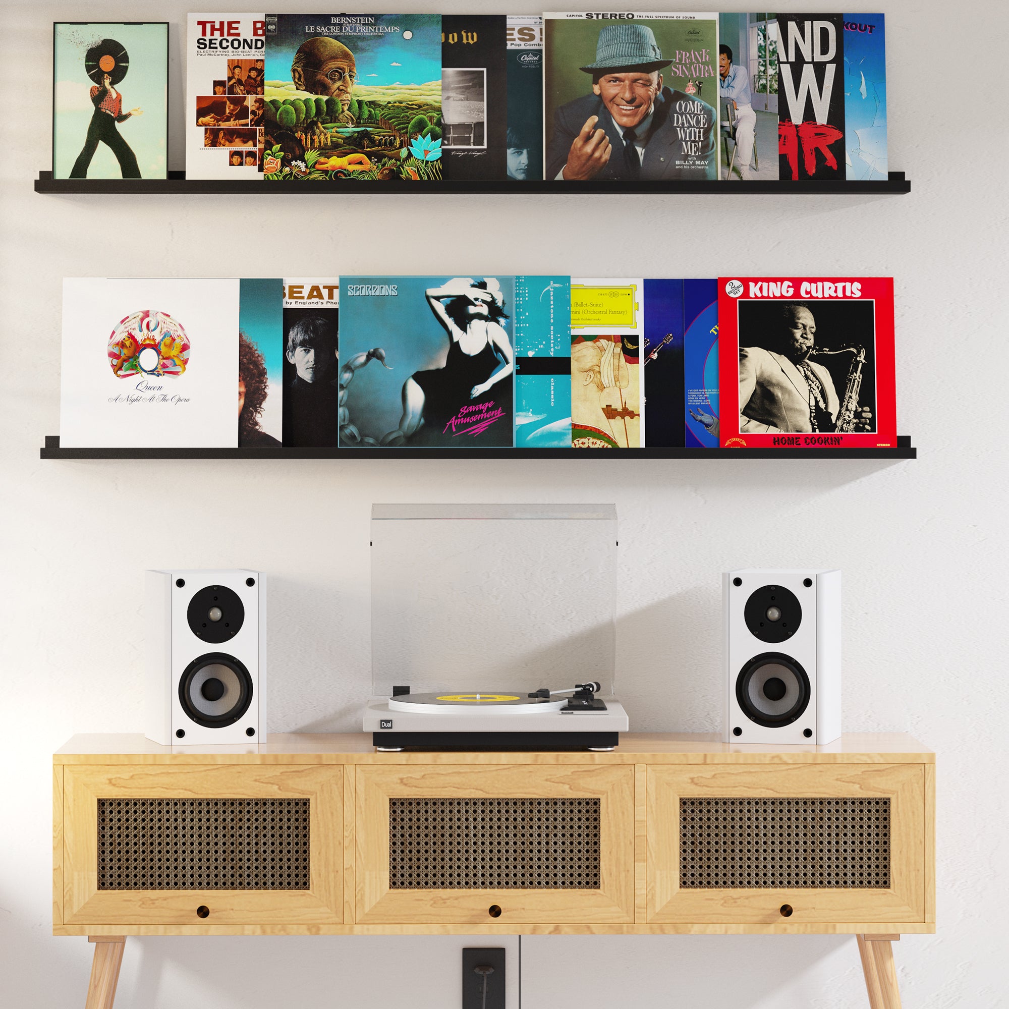 Floating shelves black with various music vinyl records and speakers on a wooden sideboard.
