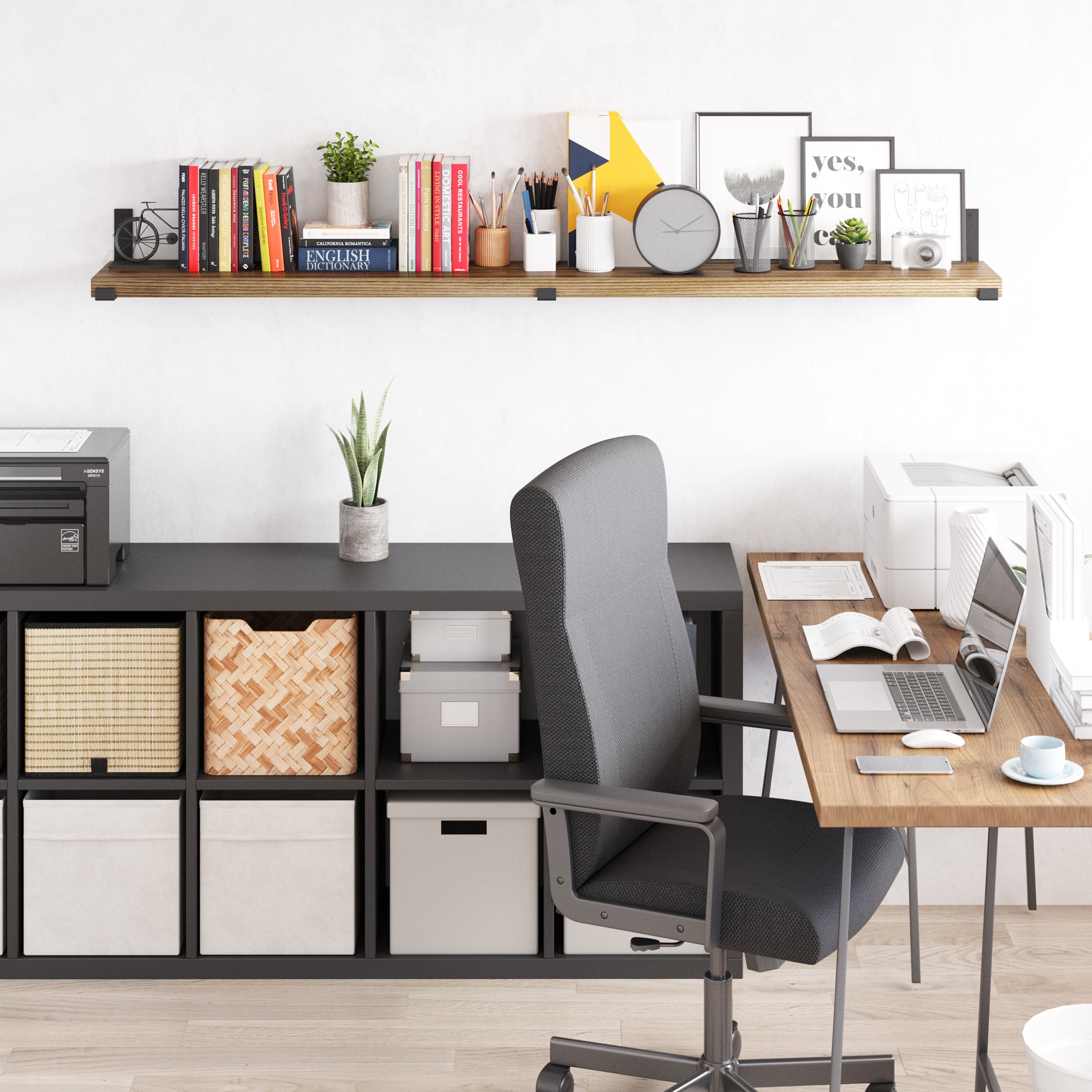 An office with organizer shelf with books, supplies, and decor.